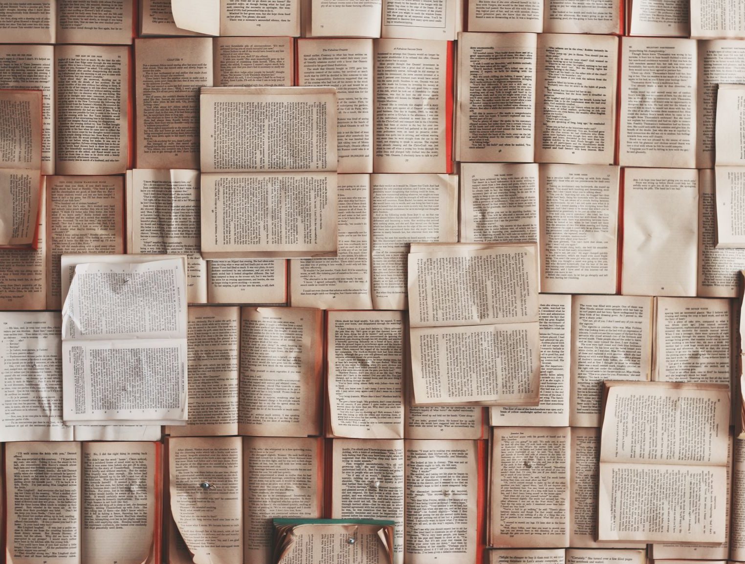Pile of books with open pages